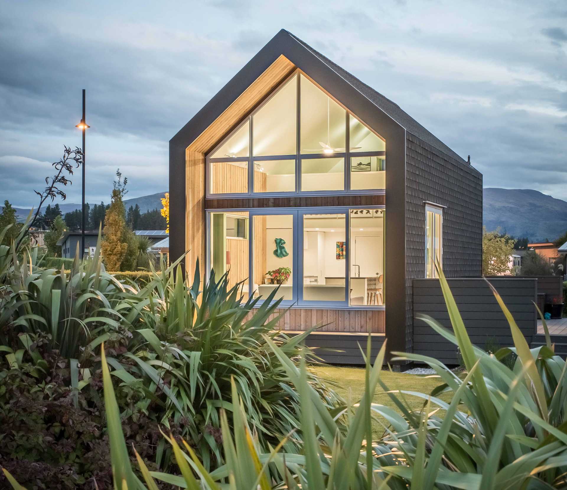 A small one bedroom home with an exterior of asphalt shingles and larch weatherboards.